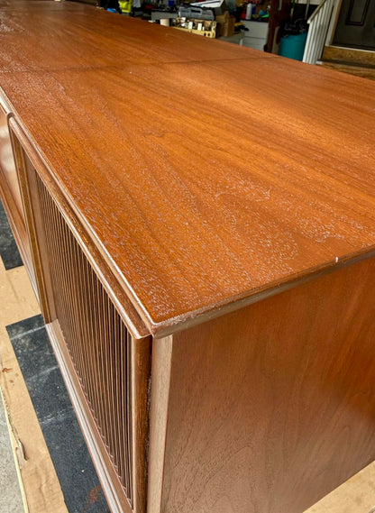 Wooden cabinet with a textured surface on a checkered floor